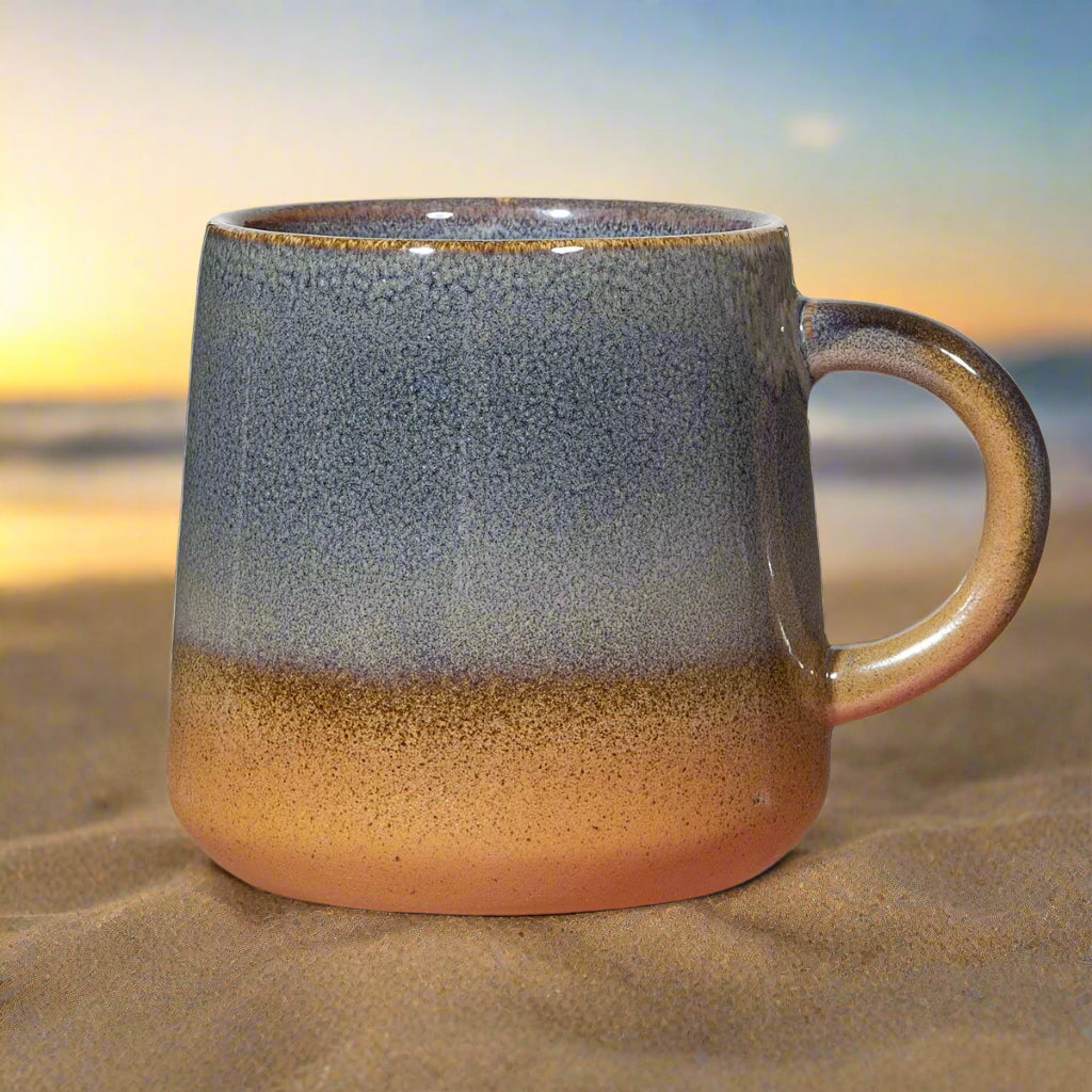 Ceramic mug with gradient blue to brown color on a white background