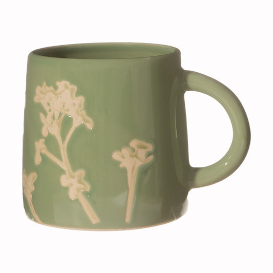 Green mug with floral design on a white background